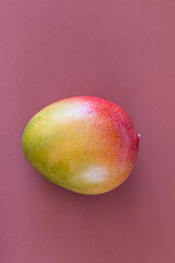 Fresh delicious mango isolated on brown background
