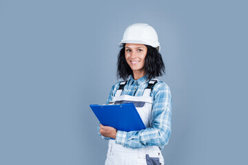 Foreman inspector. girl in checkered shirt and protective hard hat. building and construction site. Builder engineer working with documents. female worker. Architecture. woman architect in helmet