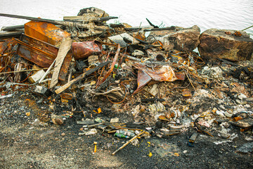 Burnt and rusty metal scrap in a pile.