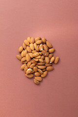 group of nuts on brown background, healthy food concept, empty space for text
