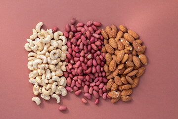 group of nuts on brown background, healthy food concept, empty space for text
