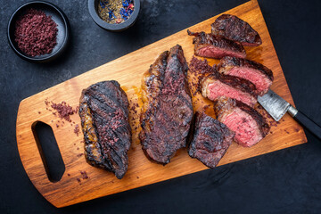 Modern style barbecue dry aged wagyu Brazilian picanha steaks from the sirloin cap of rump beef...