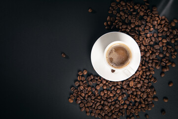 cup of coffee with coffee beans on black background