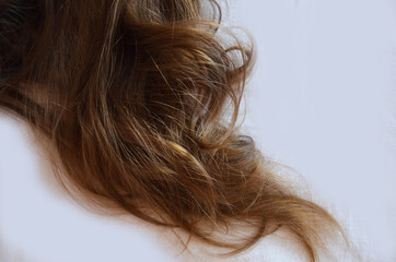 piece of brown hair on white isolated background healthy and shiny
