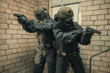 Group of special forces fighters storm the building through the window. Training sessions of the...