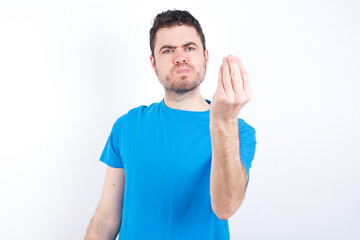 young handsome caucasian man wearing white t-shirt against white background Doing Italian gesture with hand and fingers confident expression