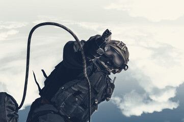 Image of a special unit soldier jumping from a helicopter. Military concept. Anti-terrorism.