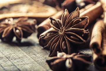 Detail of star anize and cinnamon sticks on a vintage wooden surface