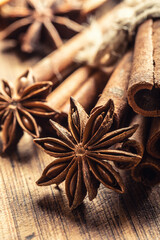 Detail of star anize and cinnamon sticks on a vintage wooden surface