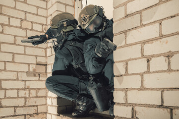 Group of special forces fighters storm the building through the window. Training sessions of the...