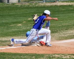 Action photo of high school baseball players making amazing plays during a baseball game