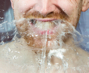 Fototapeta premium Whte man under shower water streams, dynamic face with beard