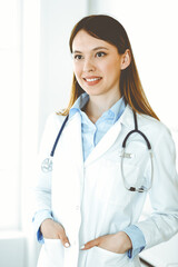 Asian doctor woman happy and cheerful while standing in hospital office. Medicine concept