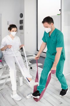 Team of physiotherapists practicing exercises for helping patients. High quality photo