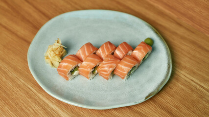 Top view of set of Philadelphia sushi rolls with salmon, avocado, cream cheese on white plate
