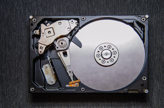 Disassembled hard drive from the computer, hdd with mirror effect. Opened hard drive from the computer hdd with mirror effects. Part of computer pc, laptop