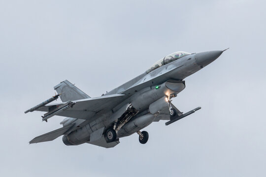 The F-16 Fighting Falcon take-off silhouetted against the gray sky