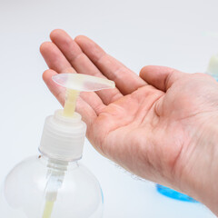 man washes his hands with liquid soap, hygiene products