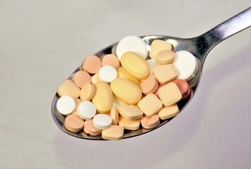 a spoon with many pills