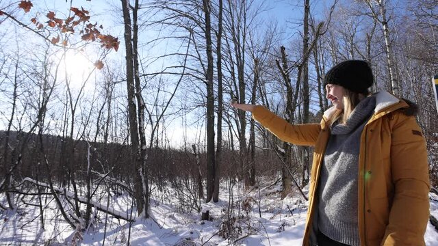 pretty woman feeding birds by hand sunny winter forest slomo