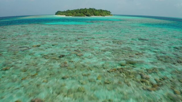 Aerial view of a tropical island in the Indian Ocean. Thinadhoo (Vaavu Atoll), Maldives