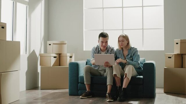 Couple holds white paper plan and discuss flat renovation