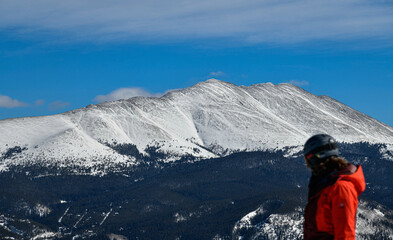 Man on the top of the mountain enjoys spectacular landscape in Breckenridge , CO.