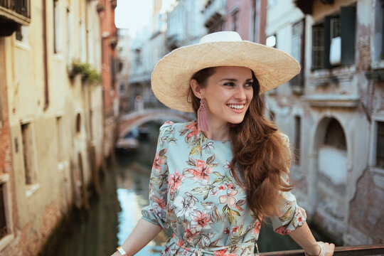 Fototapeta happy trendy woman in floral dress exploring attractions