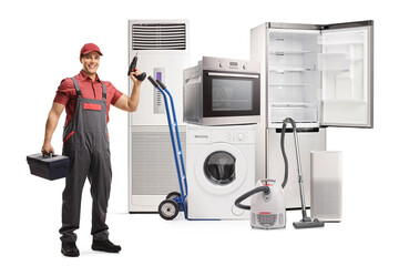 Full length portrait of a repairman with a tool box and a drill standing in front of home appliances