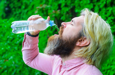 Bearded man drinking water. Hydration concept. Guy with water bottle. Healthy lifestyle.
