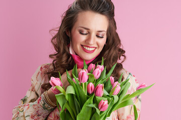 trendy woman with long wavy brunette hair on pink