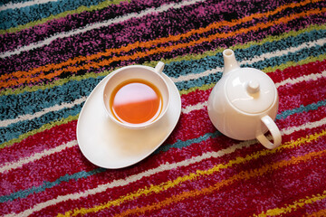 Tea and teapot on the colorful floor