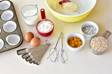 Baking ingredients and kitchen utensils for making healthy gourmet muffins and baked goods. Photo...