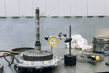 Set of various engine and gearbox spare parts. Shiny gears for planetary gearbox.Metal autotechnology background. wheel engine gears, close up. Automatic transmission in section	