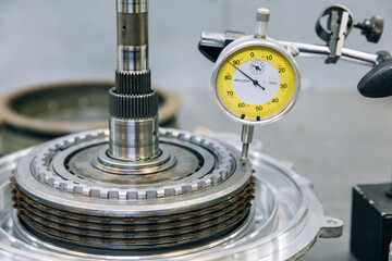 Set of various engine and gearbox spare parts. Shiny gears for planetary gearbox.Metal autotechnology background. wheel engine gears, close up. Automatic transmission in section	