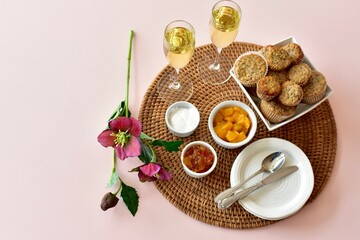 Simple breakfast brunch pastry muffins and champagne for  Mother's Day morning in bed or romantic holiday weekend. Photo concept food background, close-up, copy space