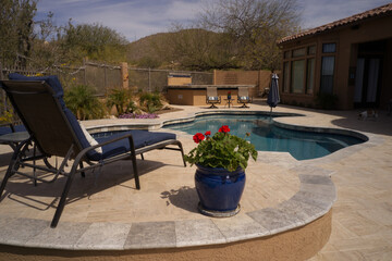 A desert landscaped back yard in Arizona featuring travertine tile.