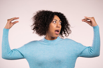 Pretty african woman showing bla-bla-bla gesture with hands and rolling eyes isolated on white background. Empty promises, blah concept. Lier.