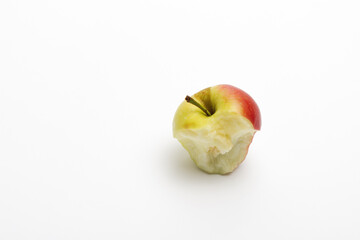 Red delicious bitten apple isolated on white. An apple stub.