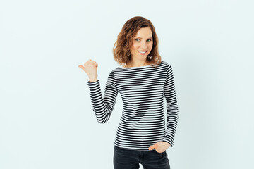 Happy young woman wearing casual striped shirt and black jeans