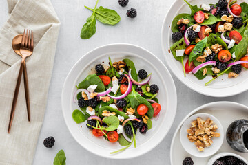 Top down view of blackberry spinach salads ready for eating.