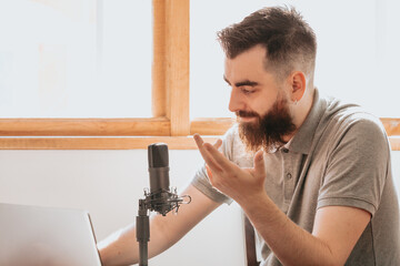 Close up of a streaming microphone while a man chats working streaming with copy space concept