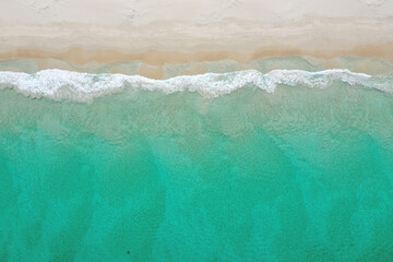 Crystal clear ocean water and sandy beach on a peaceful summer day in Perth.