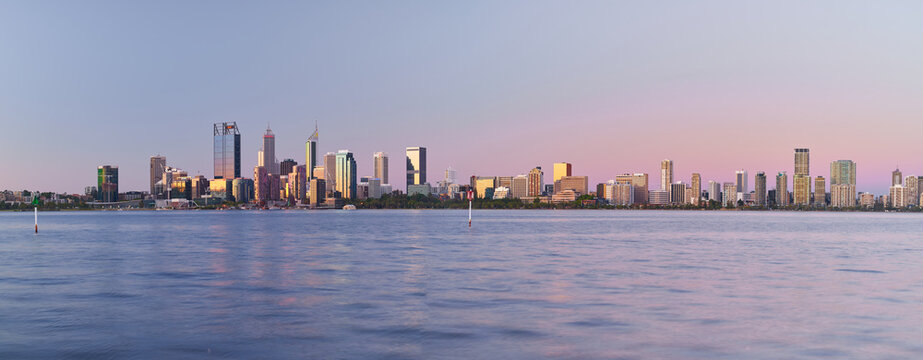 Panoramic view of the Perth skyline across the Swan River at dusk.