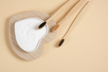 eco-friendly bamboo teethbrush. bamboo toothbrushes and baking soda on beige background