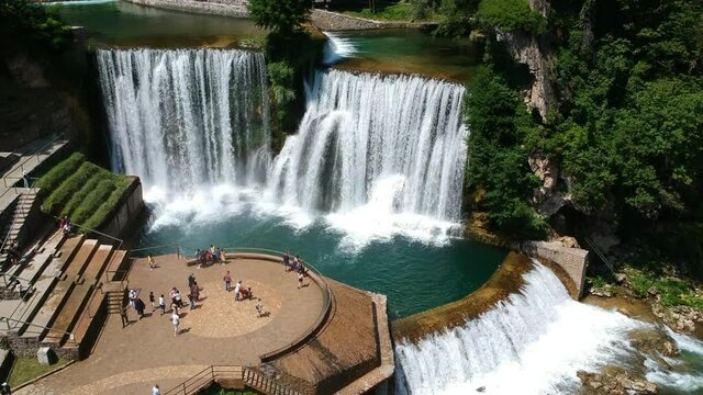 Jajce, Bosnia and Herzegovina - July 13, 2019. Viewpoint with tourists in Jajce waterfall in Bosnia and Herzegovina, Europe