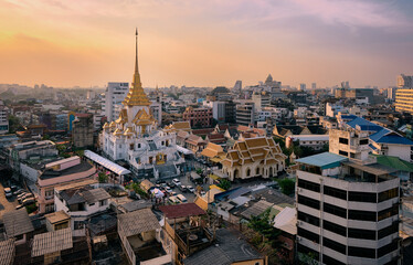 Fototapeta na wymiar Bangkok, Thailand skyline at Temple of the Golden Buddha, Wat Traimit Temple, at sunset. Travel destination