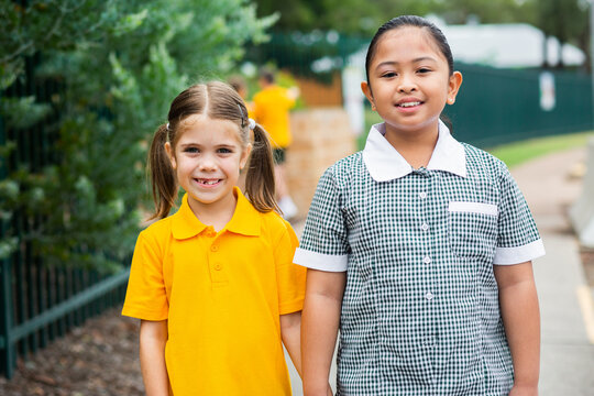 Portrait of two happy school girls looking forward to going back to school