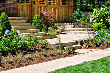 Huge natural stone slab flagstone steps create beautiful landscaping and a transition to a hidden...