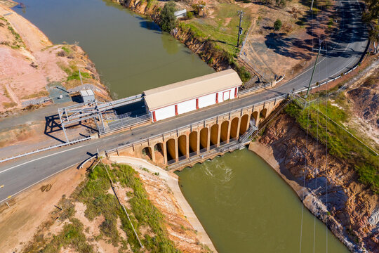 Aerial view of a road crossing over flood gates on a water channel
